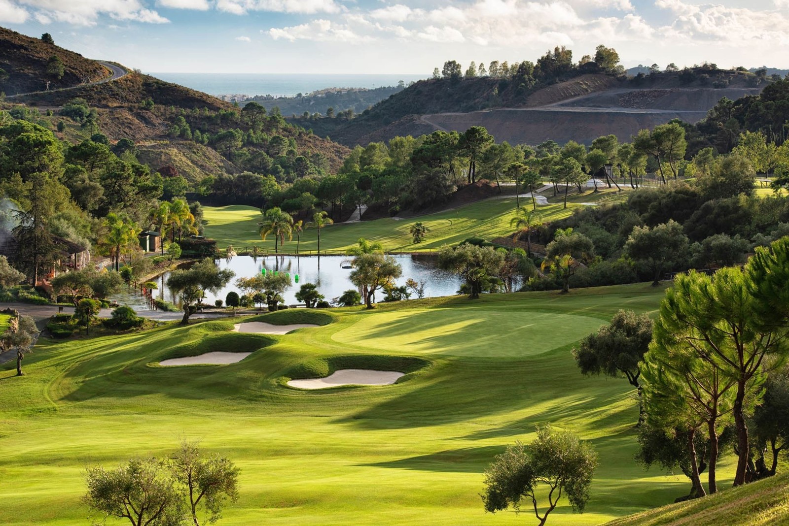 Elevated golf hole in the wooded hills of Benahavís looking down to the coastline
